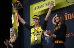 Stage winner Netherlands' Dylan Groenewegen (C) celebrates his victory on the podium of the seventh stage of the 106th edition of the Tour de France cycling race between Belfort and Chalon-sur-Saone, in Chalon-sur-Saone, eastern France, on July 12, 2019. (Photo by Anne-Christine POUJOULAT / AFP)