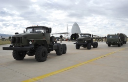 A handout photograph taken and released on July 12, 2019, by the Turkish Defence Ministry shows a Russian military cargo plane, carrying S-400 missile defence system from Russia, during its unloading at the Murted military airbase (also known as Akincilar millitary airbase), in Ankara. - The delivery to an air base in Ankara comes after Washington warned this week that there would be "real and negative" consequences if Turkey bought the defence system. NATO, which counts Turkey as one of its members, has repeatedly warned Turkey that the Russian system is incompatible with other NATO weapons systems, not least the F-35, a new generation multi-role stealth fighter jet. (Photo by TURKISH DEFENCE MINISTERY PRESS / TURKISH DEFENCE MINISTRY / AFP) / RESTRICTED TO EDITORIAL USE - MANDATORY CREDIT "AFP PHOTO / TURKISH DEFENCE MINISTRY"- NO MARKETING NO ADVERTISING CAMPAIGNS - DISTRIBUTED AS A SERVICE TO CLIENTS