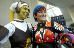 (FILES) In this file photo taken on July 23, 2016 women play the parts from Star Wars, Hera Syndulla (L) and Sabine Wren during Comic-Con International 2016 in San Diego, California. - From Peter Parker's run-in with a radioactive spider to Superman fleeing an exploding Krypton: comic book fans love a good origin story. So when 135,000 geeks and nerds invade San Diego next week for the 50th edition of Comic-Con -- the world's largest celebration of pop culture -- the event's humble beginnings will be a hot topic of discussion. (Photo by Bill Wechter / AFP)
