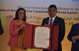 Vice President Faisal Naseem accepting certification that Maldives is free of perinatal transmission of HIV and syphilis. PHOTO: MINISTRY OF HEALTH