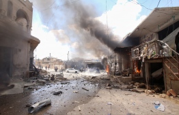 Smoke billows following an airstrike by Syrian regime forces in Maar Shurin on the outskirts of Maaret al-Numan in northwest Syria on July 16, 2019. - Regime airstrikes today killed nine civilians in rebel-held northwest Syria, the target of months of regime and Russian bombardment, war monitor the Syrian Observatory for Human Rights said. (Photo by Abdulaziz KETAZ / AFP)