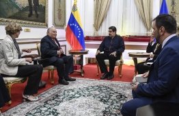 EU special adviser for Venezuela Enrique Iglesias (2-L) and Venezuelan President Nicolas Maduro (3-L) speak during a meeting at Miraflores Presidential Palace in Caracas on July 9, 2019. - Oil-rich Venezuela has been ravaged by five years of recession marked by shortages of food, medicine and other basic necessities, and the economic woes have been exacerbated by the political crisis. (Photo by Federico Parra / AFP)
