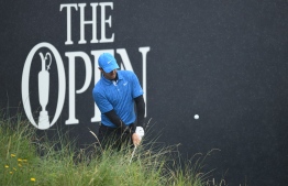 Northern Ireland's Rory McIlroy chips onto the 18th green during the first round of the British Open golf Championships at Royal Portrush golf club in Northern Ireland on July 18, 2019. (Photo by Glyn KIRK / AFP) / 