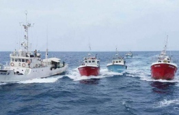 Foreign fishing boats and a vessel of the Maldives National Defence Force. PHOTO: MIHAARU