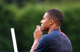 Paris Saint-Germain's French forward Kylian Mbappe looks on during a training session in Shenzhen on August 1, 2019, ahead of the French Trophy of Champions football match between Rennes and Paris Saint-Germain. (Photo by FRANCK FIFE / AFP)