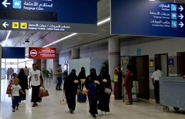 (FILES) In this file photo taken on June 13, 2019 shows Saudi women arriving at Abha airport in the popular mountain resort of the same name in the southwest of Saudi Arabia. - Saudi Arabia will allow women to obtain passports and travel abroad without approval from a male "guardian", the government said on August 2, ending a longstanding restriction that drew heavy international criticism. (Photo by Fayez Nureldine / AFP)