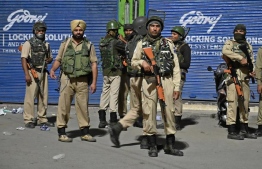 Indian paramilitary troopers stand guard at a roadblock at Maisuma locality in summer capital Srinagar on August 4, 2019. Some 40,000 fresh troops were reportedly deployed in addition to 500,000 already in the disputed region. PHOTO: AFP