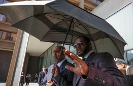 (FILES) In this file photo taken on June 26, 2019 R. Kelly leaves the Leighton Criminal Court Building after a hearing on sexual abuse charges in Chicago, Illinois. - R&B singer R. Kelly pleaded not guilty on August 2, 2019 in a New York court to federal charges including racketeering that allege he systematically recruited girls for sex while touring. (Photo by KAMIL KRZACZYNSKI / AFP)