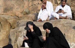 Smartphones are rapidly replacing traditional printed holy books as a means to read Koranic verses. PHOTO: AFP