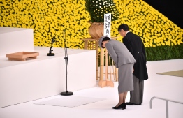 Japan's Emperor Naruhito (R) and Empress Masako (L) bow at an altar during an annual memorial ceremony to remember those lost at war, on August 15, 2019, in Tokyo as the country marks the 74th anniversary of its surrender in World War II. (Photo by Kazuhiro NOGI / AFP)