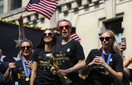 (FILES) In this file photo taken on July 10, 2019 Megan Rapinoe (C) and other members of the World Cup-winning US women's team take part in a ticker tape parade for the women's World Cup champions in New York. - US women's football players reached an impasse August 14, 2019, in mediation with the US Soccer Federation in their dispute over equal pay with the American men's squad. Molly Levinson, a spokesperson for the US women's players, said the group will "eagerly look forward to a jury trial." (Photo by Johannes EISELE / AFP)