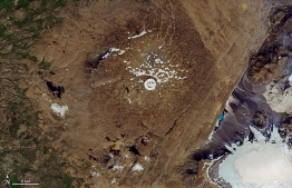 This NASA handout image taken on August 1, 2019 shows the top of the Ok Volcano where the Okjokull glacier has melted away throughout the 20th century and was declared dead in 2014. Iceland is planning to mark the passing of Okjokull, its first glacier lost to climate change which threatens some 400 others on the subarctic island. - On August 18, a plaque will be unveiled to Okjokull -- which translates to "OK glacier" -- in the west of Iceland, local  researchers and their peers at Rice University in the United States, who initiated the project, said on July 2. (Photo by - / NASA / AFP) / 