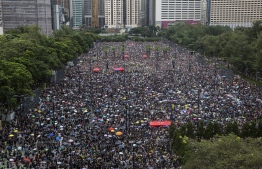 Protesters gather for a rally in Victoria Park in Hong Kong on August 18, 2019, in the latest opposition to a planned extradition law that has since morphed into a wider call for democratic rights in the semi-autonomous city. - Hong Kong democracy activists gathered August 18 for a major rally to show the city's leaders their protest movement still attracts wide public support despite mounting violence and increasingly stark warnings from Beijing. (Photo by ISAAC LAWRENCE / AFP)