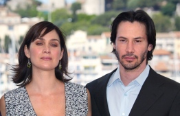US actor Keanu Reeves and Canadian-born actress Carrie-Anne Moss pose for photographers on a terrace of the Palais des festivals during the photocall for "Matrix Reloaded" directed by the Wachowski brothers during the 56th Cannes film festival on 15 May 2003. - Sci-fi franchise "The Matrix" will return for a fourth film with Keanu Reeves reprising his role as kung fu-kicking, shades-wearing hero Neo, studio Warner Bros said Tuesday.
Lana Wachowski will helm the project, returning to write, direct and produce the latest installment of the hugely popular series about humans trapped in a virtual reality by machines, which has netted more than $1.6 billion worldwide. (Photo by FRANCOIS GUILLOT / AFP) / ALTERNATIVE CROP