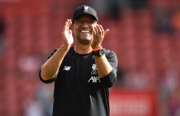 Liverpool's German manager Jurgen Klopp applauds supporters on the pitch after the English Premier League football match between Southampton and Liverpool at St Mary's Stadium in Southampton, southern England on August 17, 2019. - Liverpool won the game 2-1. (Photo by Glyn KIRK / AFP) / RESTRICTED TO EDITORIAL USE. No use with unauthorized audio, video, data, fixture lists, club/league logos or 'live' services. Online in-match use limited to 120 images. An additional 40 images may be used in extra time. No video emulation. Social media in-match use limited to 120 images. An additional 40 images may be used in extra time. No use in betting publications, games or single club/league/player publications. / 
