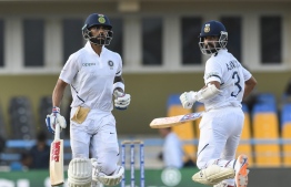 Virat Kohli (L) and Ajinkya Rahane (R) of India 100 partnership during day 3 of the 1st Test between West Indies and India at Vivian Richards Cricket Stadium in North Sound, Antigua and Barbuda, on August 24, 2019. (Photo by Randy Brooks / AFP)