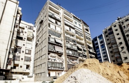 This picture taken on August 25, 2019 shows damage to a building housing a media centre of the Lebanese Shiite group Hezbollah in the south of the capital Beirut, after two drones came down in its vicinity earlier in the day. - Hezbollah said on August 25 that one of the drones was rigged with explosives and caused damage to its media centre, but denied shooting down any of them. The early morning incident came hours after Israel launched air strikes in neighbouring Syria, but Hezbollah officials could not confirm if the drones deployed in Lebanon were Israeli. Another Hezbollah source told AFP the Iran-backed Shiite militant group -- a major political player in Lebanon with representatives in parliament and the government -- has not determined if the drones were Israeli. (Photo by ANWAR AMRO / AFP)