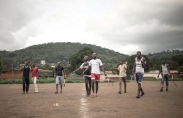Ngbaba players contest a penalty kick during a game in Bangui, on August 8, 2019. - Ngbaba is a traditional Central African sport which fell into disuse in the 2000s due to the security situation in the country, and it is being revived by young enthusiasts thanks to the lull in the conflict. (Photo by FLORENT VERGNES / AFP)