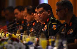 Sri Lanka's new army chief Lieutenant General Shavendra Silva (2R) looks on during a press conference in Colombo on August 26, 2019. - Sri Lanka's new army chief on August 26 brushed aside international outrage over his appointment, saying "anyone can make allegations" that he had committed war crimes. (Photo by ISHARA S. KODIKARA / AFP)