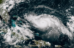 This satellite image obtained from NOAA/RAMMB, shows Tropical Storm Dorian as it approaching the Bahamas and Florida at 17:40 UTC on August 30, 2019. - Hurricane Dorian -- expected to barrel into Florida early next week -- has strengthened into a major category 3 storm on Friday, US meteorologists announced. Dorian has become an "extremely dangerous hurricane" packing maximum sustained winds of 115mph (185kph), the Miami-based National Hurricane Center said. The storm is projected to intensify even more before it makes landfall in the southern US state of Florida on Monday or Tuesday, the NHC said. (Photo by HO / NOAA/RAMMB / AFP) / 