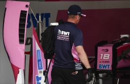 A member of British formula racing team BWT Arden carries a bag in the pits after BWT Arden's French driver Anthoine Hubert was involved in a serious accident with several drivers during a Formula 2 race at the Spa-Francorchamps circuit in Spa, Belgium, on August 31, 2019. - French driver Anthoine Hubert, 22, was killed on August 31 in Spa in an accident during a Formula 2 race held on the sidelines of the F1 Grand Prix, according to organizers of the race. (Photo by JOHN THYS / AFP)