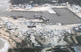 In this image courtesy of US Coast Guard Air Station Clearwater, boats are strewn across a marina in in Andros Island, Bahamas, on September 2, 2019, as Hurricane Dorian makes its way across the Bahamas. - Dorian crept towards the southeast coast of the US on September 3, 2019, weakening slightly but remaining a dangerous storm after leaving a trail of death and destruction in the Bahamas. At least five deaths have been reported in the Bahamas from a storm which Prime Minister Hubert Minnis called a "historic tragedy" for the Atlantic archipelago.The Miami-based National Hurricane Center said Dorian, which has dumped as much as 30 inches (76 centimeters) of rain on the Bahamas, had been downgraded from a Category 3 to a Category 2 storm on the five-level wind scale. (Photo by HO / US Coast Guard / AFP) / 