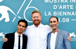 US director Matthew Michael Carnahan (C) poses together with Iraqi actor Suhail Dabbach (R) and actor Adam Bessa during a photo call for the film 'Mosul', presented out of competition, at the 76th Venice Film Festival at Venice Lido on September 4, 2019. 
Alberto PIZZOLI / AFP