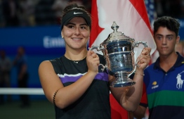 Bianca Andreescu of Canada holds her trophy after she won against Serena Williams of the US after the Women's Singles Finals match at the 2019 US Open at the USTA Billie Jean King National Tennis Center in New York on September 7, 2019. (Photo by TIMOTHY A. CLARY / AFP)