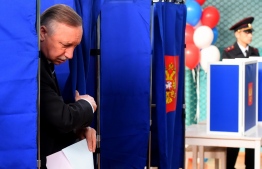 Acting Saint-Petersburg Governor Alexander Beglov gets out of a polling booth prior to casting his vote at a polling station during the governor's election in Saint Petersburg on September 8, 2019. - Russians vote in local and regional elections on September 8, 2019. (Photo by Olga MALTSEVA / AFP)
