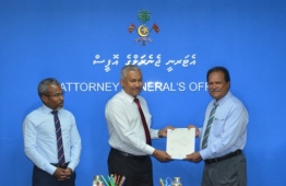 Ahmed Shiyau being handed the letter of appointment at a ceremony held at the Attorney General's Office. PHOTO: CIVIL SERVICE COMMISSION (CSC)