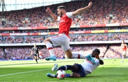 Arsenal's German-born Bosnian defender Sead Kolasinac is tackled by Tottenham Hotspur's French midfielder Moussa Sissoko during the English Premier League football match between Arsenal and Tottenham Hotspur at the Emirates Stadium in London on September 1, 2019. (Photo by Ben STANSALL / AFP) / RESTRICTED TO EDITORIAL USE. No use with unauthorized audio, video, data, fixture lists, club/league logos or 'live' services. Online in-match use limited to 120 images. An additional 40 images may be used in extra time. No video emulation. Social media in-match use limited to 120 images. An additional 40 images may be used in extra time. No use in betting publications, games or single club/league/player publications. / 
