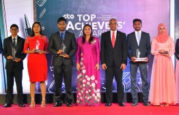 Education Minister Dr Aishath Ali (L-5) and President Ibrahim Mohamed Solih (R-5) pose for a photograph with students that achieved top marks nationwide in the 2018 GCE O' Level examinations, during the Top Achievers Awards ceremony held in September 2019. FILE PHOTO: HUSSAIN WAHEED / MIHAARU