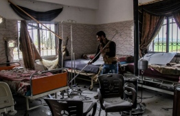 A man pictured inside a hospital allegedly hit by a regime airstrike in the town of Saraqib, northern Idlib province, on March, 2019. PHOTO: AMER ALHAMWE / AFP