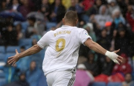 Real Madrid's French forward Karim Benzema celebrates after scoring during the Spanish league football match Real Madrid CF against Levante UD at the Santiago Bernabeu stadium in Madrid on September 14, 2019. (Photo by CURTO DE LA TORRE / AFP)