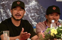 (FILES) In this file photo taken on May 28, 2019 mountaineer Nirmal Purja speaks as Nepali mountaineer Mingma David Sherpa (R) looks on during a press conference in Kathmandu. - The current record for reaching the top of the world's 14 tallest peaks is almost eight years. Nepali climber and former British special forces soldier Nirmal Purja's target is seven months. (Photo by PRAKASH MATHEMA / AFP)