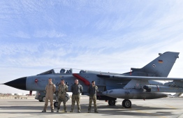 (FILES) In this file photo taken on January 13, 2018 German air force pilots stand in front of a Tornado reconnaissance aircraft  at the Al Azraq air base in Jordan as the German Defence visited the German contingent there. - Germany on September 18, 2019 extended by one year its military contribution to the multinational coalition against the Islamic State group but decided to end its Tornado reconnaissance flights in six months. (Photo by John MACDOUGALL / AFP)