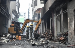 Maldives National Defence Force (MNDF) operating at the damage site following the fire. PHOTO: HUSSAIN WAHEED/ MIHAARU