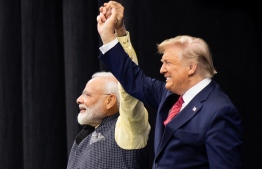 US President Donald Trump and Indian Prime Minister Narendra Modi attend "Howdy, Modi!" at NRG Stadium in Houston, Texas, September 22, 2019. - Tens of thousands of Indian-Americans converged on Houston on Sunday for an unusual joint rally by Donald Trump and Narendra Modi, a visible symbol of the bond between the nationalist-minded leaders. With many in the crowd decked out in formal Indian attire or the signature saffron of Modi's Bharatiya Janata Party, the event kicked off in a football stadium with a Sikh blessing, boisterous bhangra dancing and, in a nod to local customs, cheerleaders in cowboy hats. (Photo by SAUL LOEB / AFP)