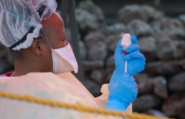 (FILES) In this file photograph taken on August 7, 2019, a nurse prepares a vaccine against Ebola in Goma,  eastern Democratic Republic of the Congo. - The Democratic Republic of the Congo is to introduce a second vaccine next month to combat the Ebola virus, which has killed more than 2,100 people in the country, the World Health Organization said September 23, 2019. The announcement came as the aid group Doctors Without Borders (MSF) accused the WHO of rationing the first Ebola vaccine in the DRC. (Photo by Augustin WAMENYA / AFP)