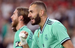 Real Madrid's French forward Karim Benzema celebrates his goal during the Spanish league football match between Sevilla FC and Real Madrid CF at the Ramon Sanchez Pizjuan stadium in Seville on September 22, 2019. (Photo by CRISTINA QUICLER / AFP)