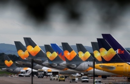 Thomas Cook logos are pictured on the tailfins of the company's passenger aircraft parked on tarmac at Manchester Airport in Manchester, northern England on September 23, 2019, after the company collapsed into bankruptcy. British travel firm Thomas Cook collapsed into bankruptcy on Monday, leaving some 600,000 holidaymakers stranded and sparking the UK's biggest repatriation since World War II. The 178-year-old operator, which had struggled against fierce online competition for some time and which had blamed Brexit uncertainty for a recent drop in bookings, was desperately seeking £200 million ($250 million, 227 million euros) from private investors to avert collapse.
Oli SCARFF / AFP
