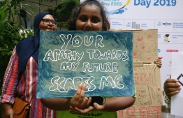 A young Maldivian girl participates in Maldives' own Climate Strike movement, inspired by Greta Thunberg, calling out for further protection of the environment, to secure her generation's right to a prosperous future by establishing a more sustainable, planet-friendly way forward. PHOTO: MIHAARU