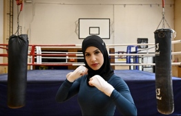 German boxer Zeina Nassar poses during a training session on August 23, 2019 in Berlin. - Berlin boxer Zeina Nassar's fighting spirit has won her plenty of titles, but her battle to wear the hijab in the ring has also made her an equal opportunity champion. (Photo by Tobias SCHWARZ / AFP)