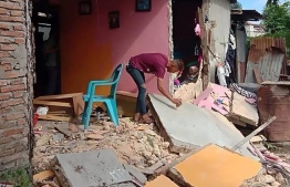 A resident inspects a collapsed wall of his house in Ambon, Indonesia's Maluku islands, on September 26, 2019, following a 6.5-magnitude earthquake on September 26, 2019. - A strong 6.5-magnitude earthquake hit off the remote Maluku islands in eastern Indonesia on September 26, US seismologists said, but no tsunami warning was issued. (Photo by AISYAH PUTRI / AFP)
