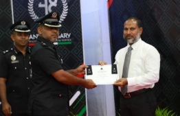 Home Minister Imran Abdulla (R) presents letter of appointment to Mohamed Asif, the first Assistant Commissioner of Prisons of Maldives Correctional Service. PHOTO/MCS
