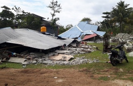 This handout picture taken and released by Indonesia's Badan Nasional Penanggulangan Bencana (BNPB), the accident mitigation agency, on September 27, 2019 shows damaged homes in Ambon, Indonesia's Maluku islands, following a 6.5-magnitude earthquake on September 26. - The death toll from a powerful earthquake that rocked Indonesia's remote Maluku islands has risen to 23, the disaster agency said Friday, as more than 15,000 people were evacuated to shelters. (Photo by Handout / BADAN NASIONAL PENANGGULANGAN BENCANA / AFP) / 