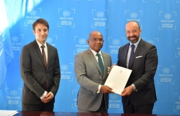 Foreign Minister Abdulla Shahid (C) signs and submits the Instruments of Ratification for three international conventions at the United Nations. PHOTO/FOREIGN MINISTRY