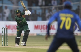 Pakistan's captain Sarfraz Ahmed (L) plays a shot during the second one day international (ODI) cricket match between Pakistan and Sri Lanka at the National Cricket Stadium in Karachi on September 30, 2019. (Photo by ASIF HASSAN / AFP)