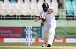 Indian cricketer Rohit Sharma plays a shot during the first day's play of the first Test match between India and South Africa at the Dr. Y.S. Rajasekhara Reddy ACA-VDCA Cricket Stadium in Visakhapatnam on October 2, 2019. (Photo by NOAH SEELAM / AFP) / 