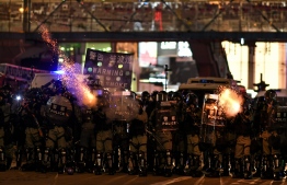 Riot police fire tear gas at protesters at Causeway Bay area in Hong Kong on October 4, 2019, as people hit the streets after the government announced a ban on facemasks. - Hong Kong's leader on October 4 invoked a rarely used colonial-era emergency law to ban people from wearing face masks in a bid to put an end to months of violent protests. (Photo by Mohd RASFAN / AFP)